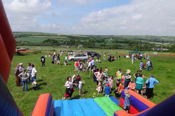 Photograph of inflatable slide and children at Kinsale races